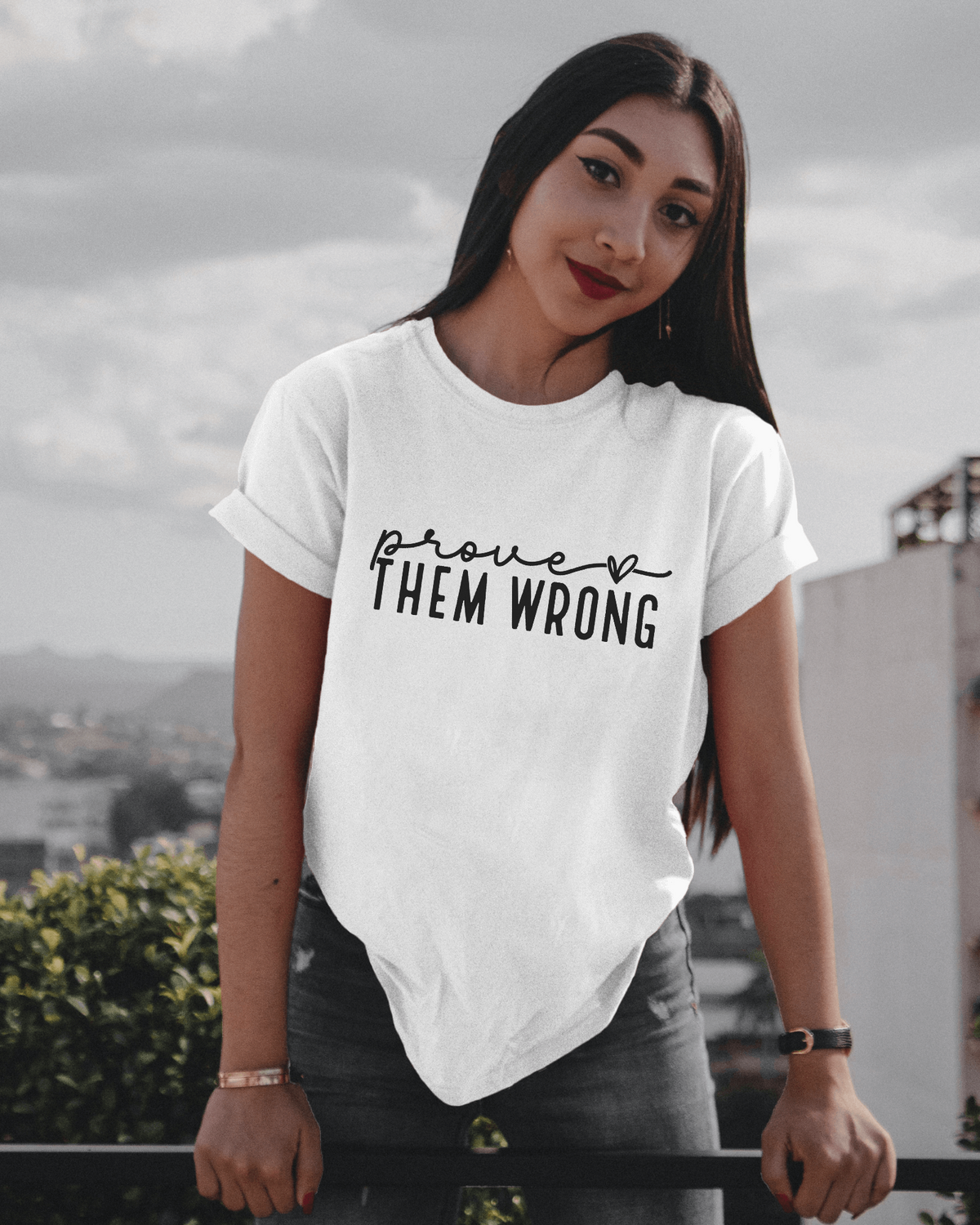 Woman wearing white t-shirt that says "Prove Them Wrong"